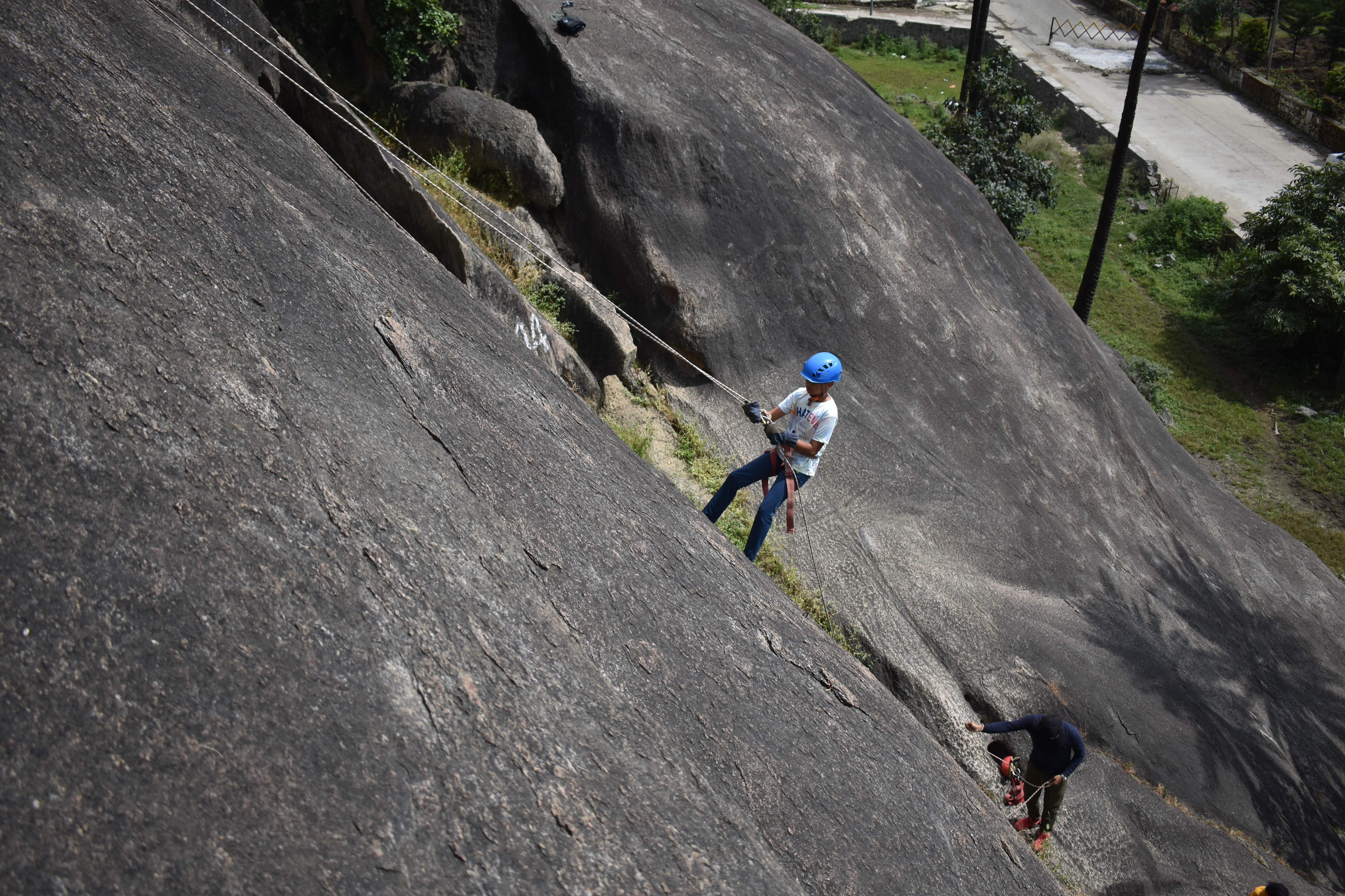Rappelling on granite rock face